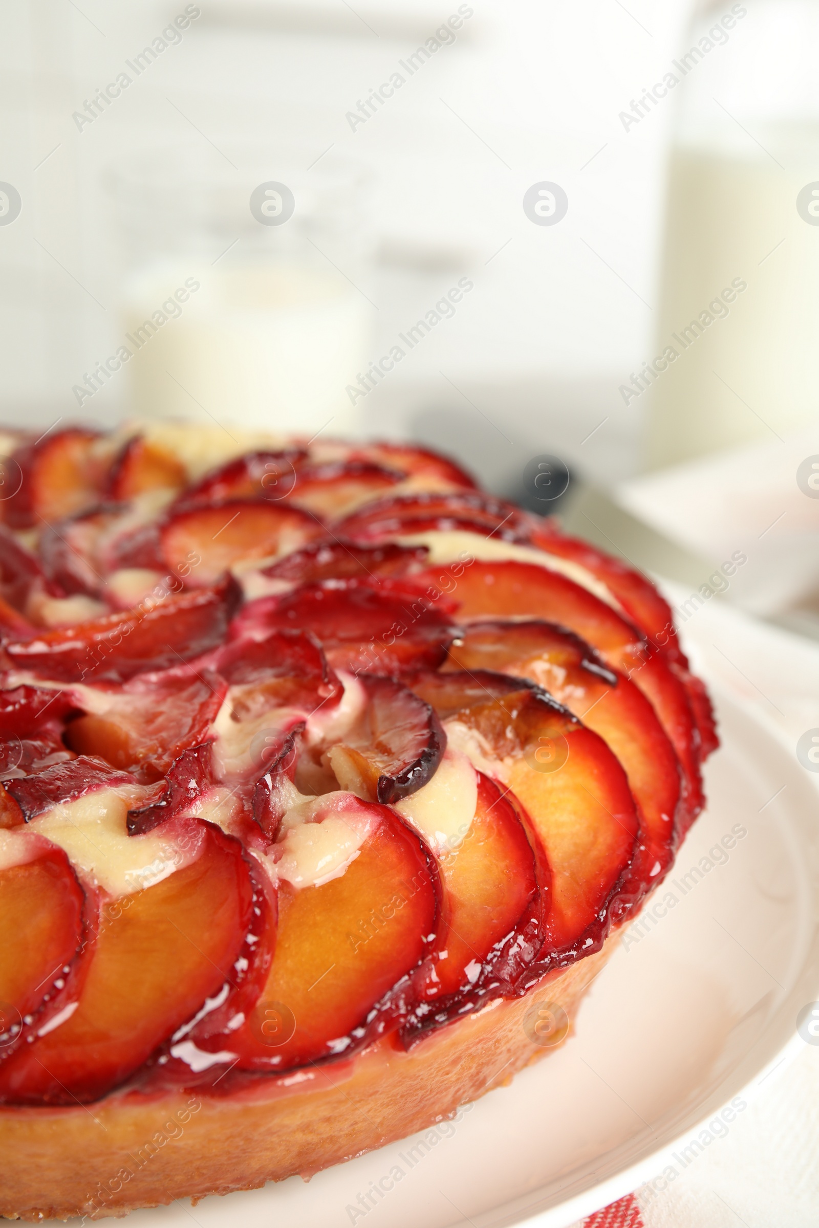 Photo of Delicious cake with plums on plate, closeup