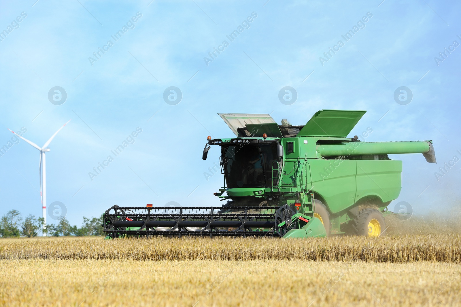 Photo of Modern combine harvester working in agricultural field