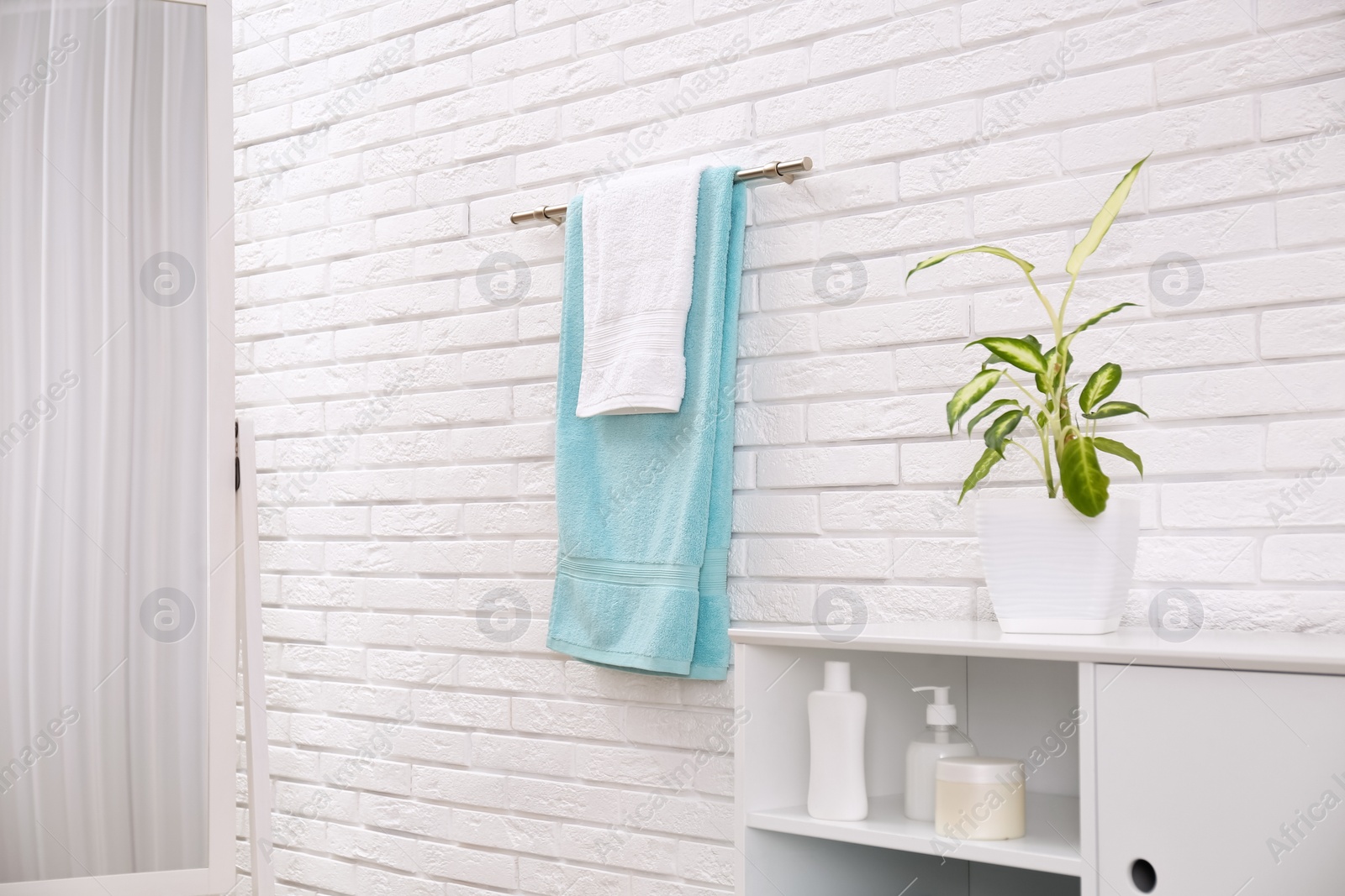 Photo of Fresh clean towels on hanger in bathroom