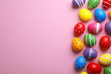 Photo of Decorated Easter eggs and space for text on color background, top view