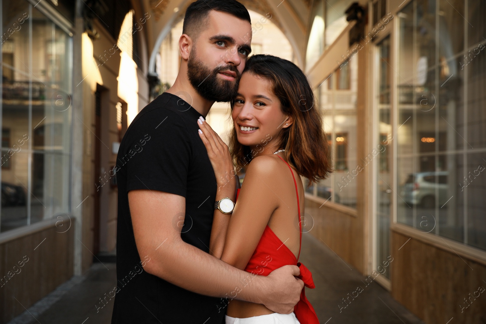 Photo of Happy young couple hugging on city street