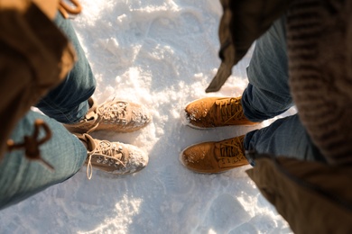 Couple standing on white snow, above view