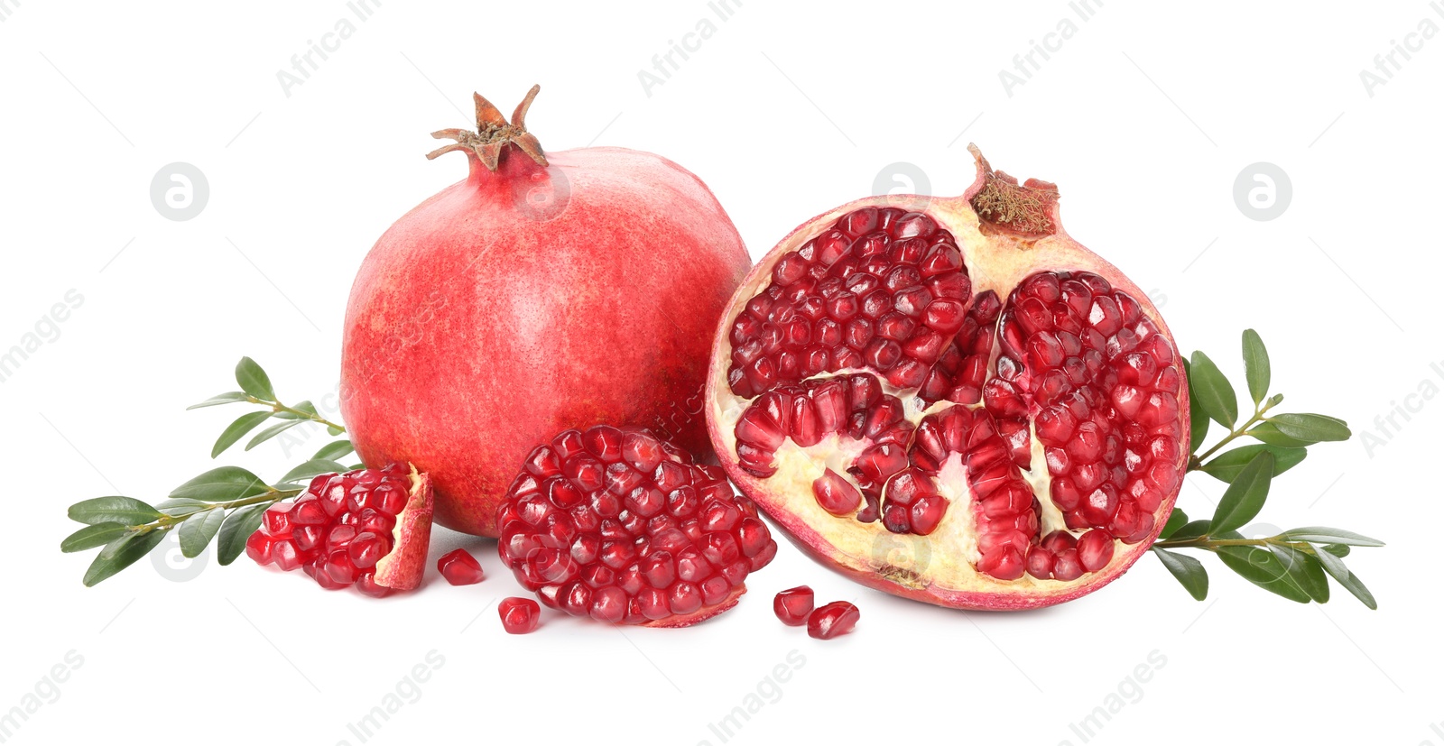 Photo of Fresh pomegranates and branches isolated on white