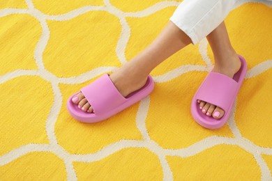 Photo of Woman in pink slippers indoors, closeup view