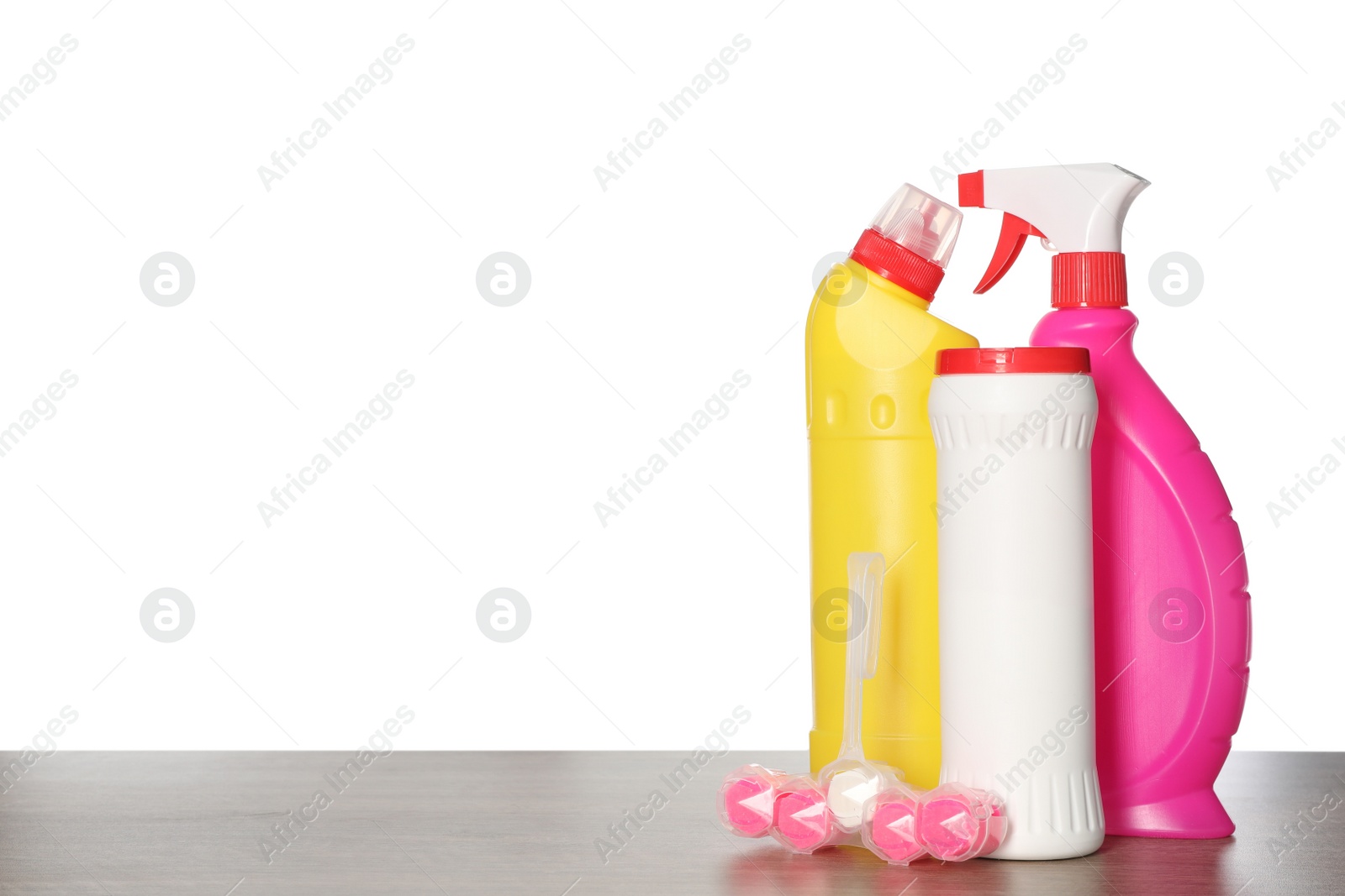Photo of Different toilet cleaning tools on wooden table against white background