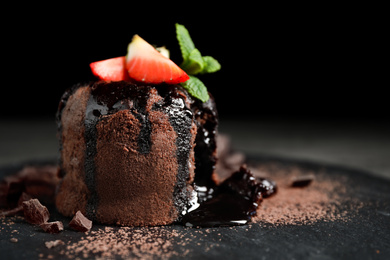 Photo of Delicious warm chocolate lava cake on slate board, closeup. Space for text