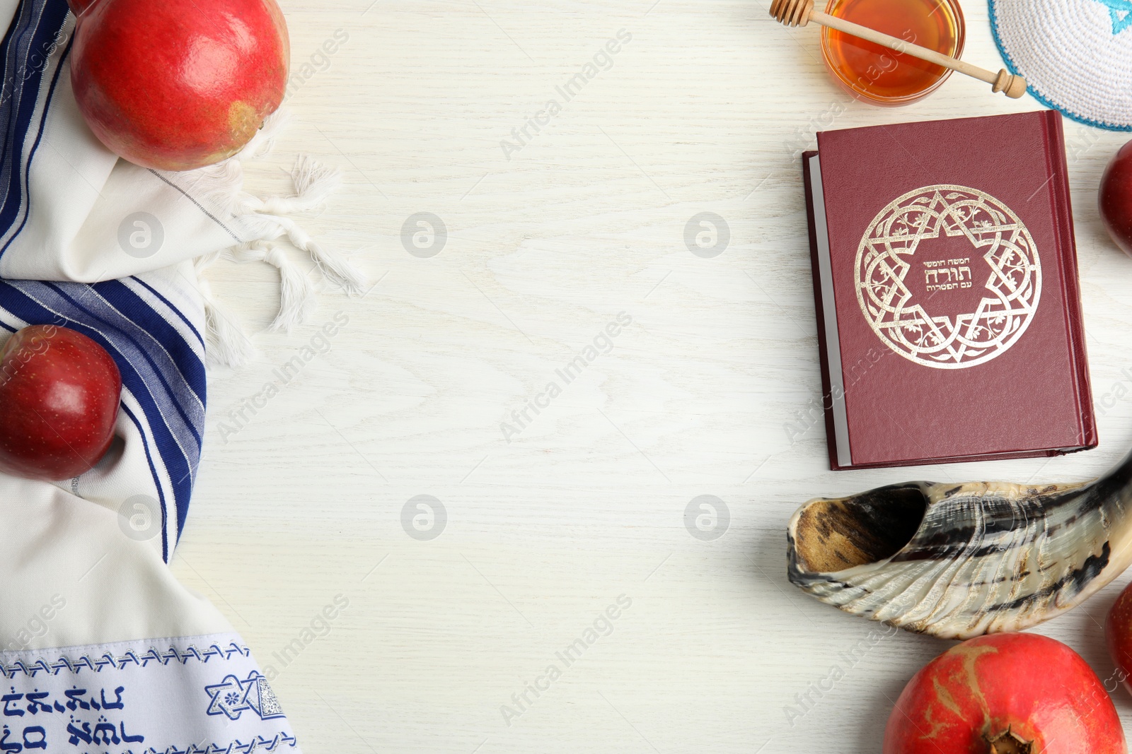 Photo of Flat lay composition with Rosh Hashanah holiday symbols on white wooden table. Space for text