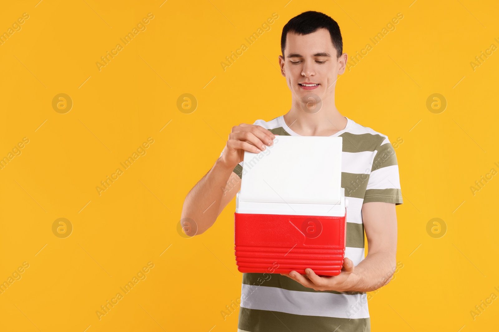 Photo of Man with red cool box on orange background, space for text