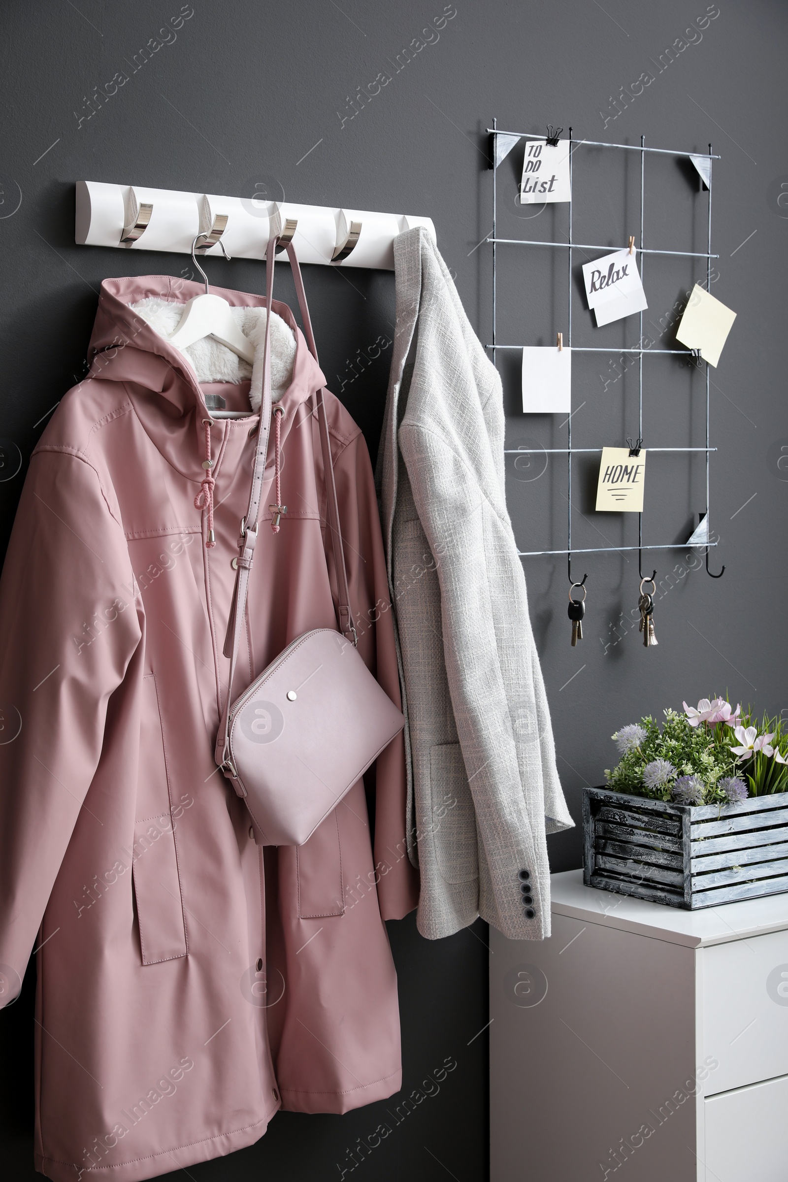 Photo of Hallway interior with stylish furniture, clothes and accessories
