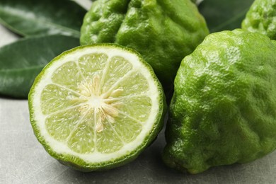 Photo of Fresh ripe bergamot fruits on light grey table, closeup