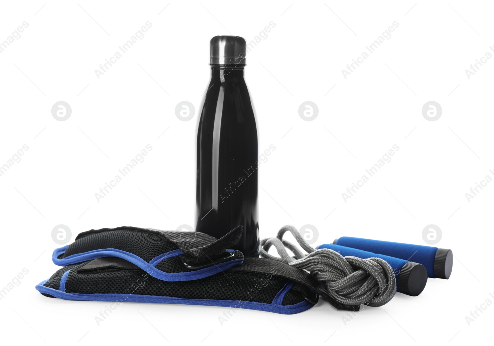 Photo of Stylish weighting agents, skipping rope and sport bottle on white background