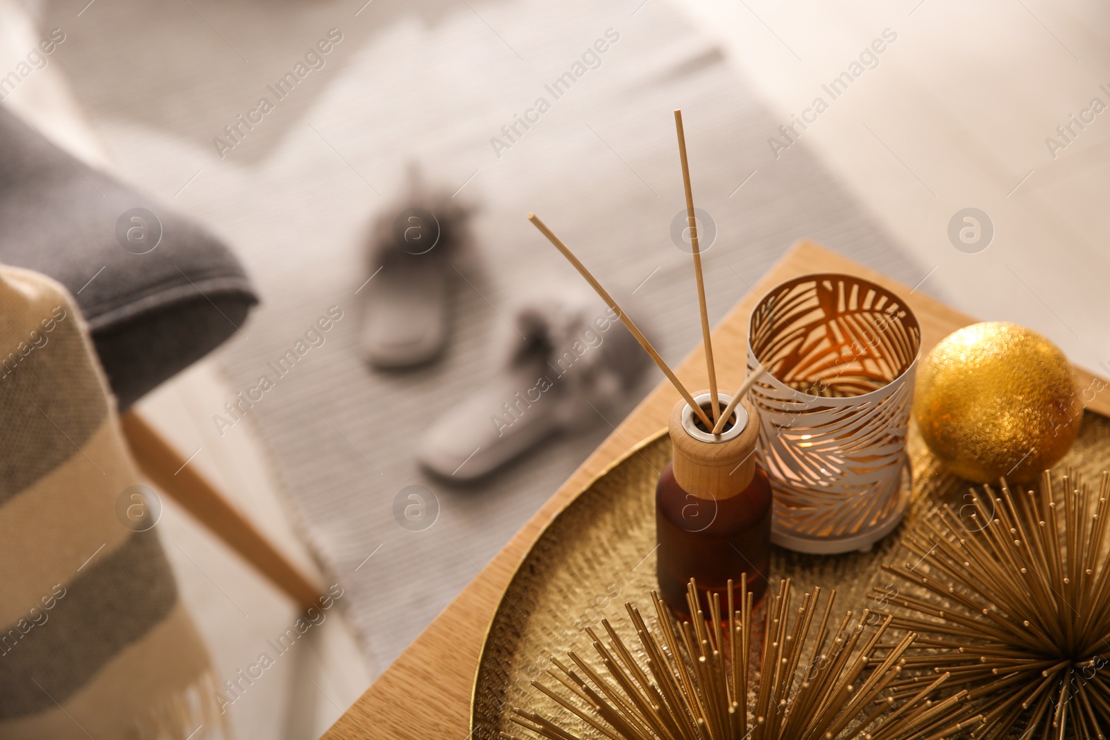 Photo of Elegant Christmas decor and reed diffuser on table indoors. Interior design