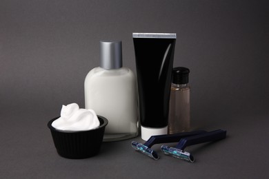 Different men's shaving accessories on grey background
