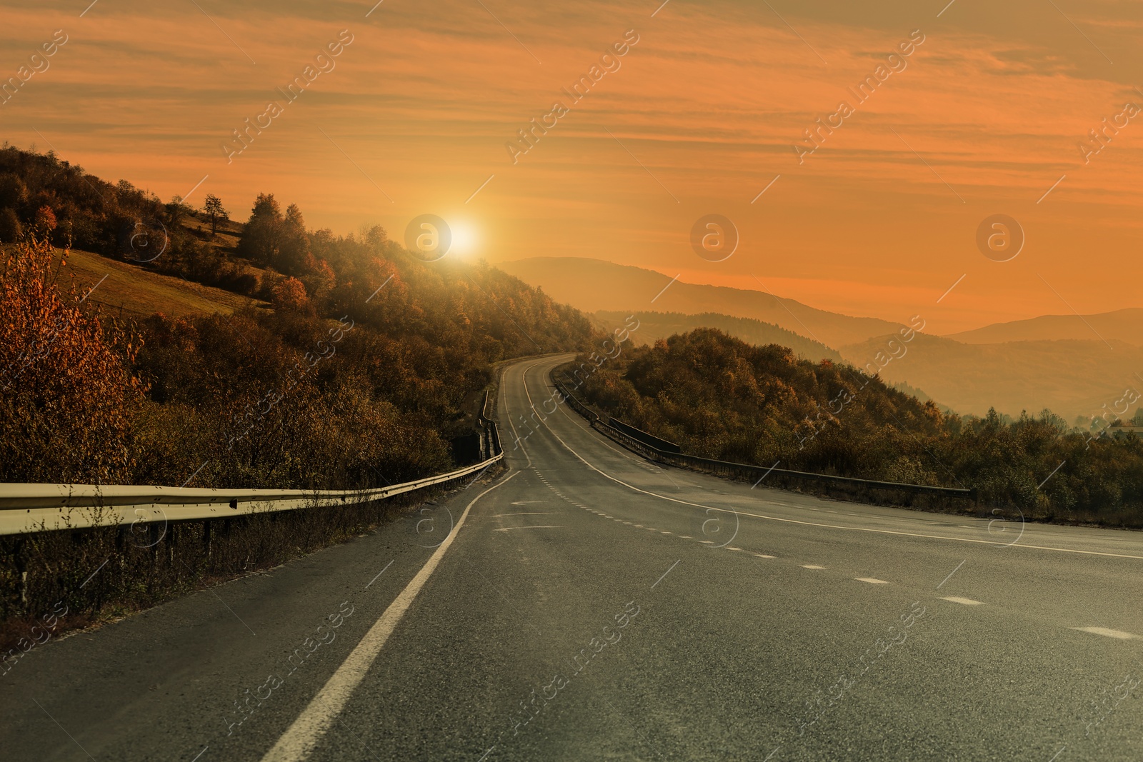 Image of Road trip. Beautiful view of asphalt highway at sunset