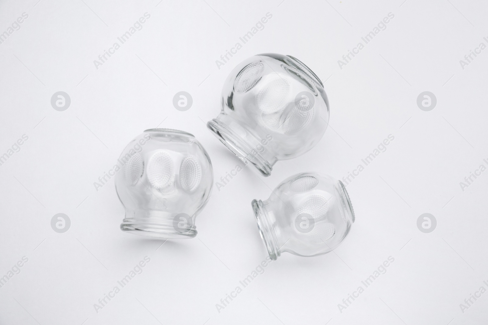 Photo of Glass cups on light grey background, flat lay. Cupping therapy