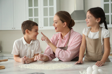 Happy family cooking together in kitchen at home