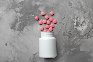 Bottle with pills on table, flat lay