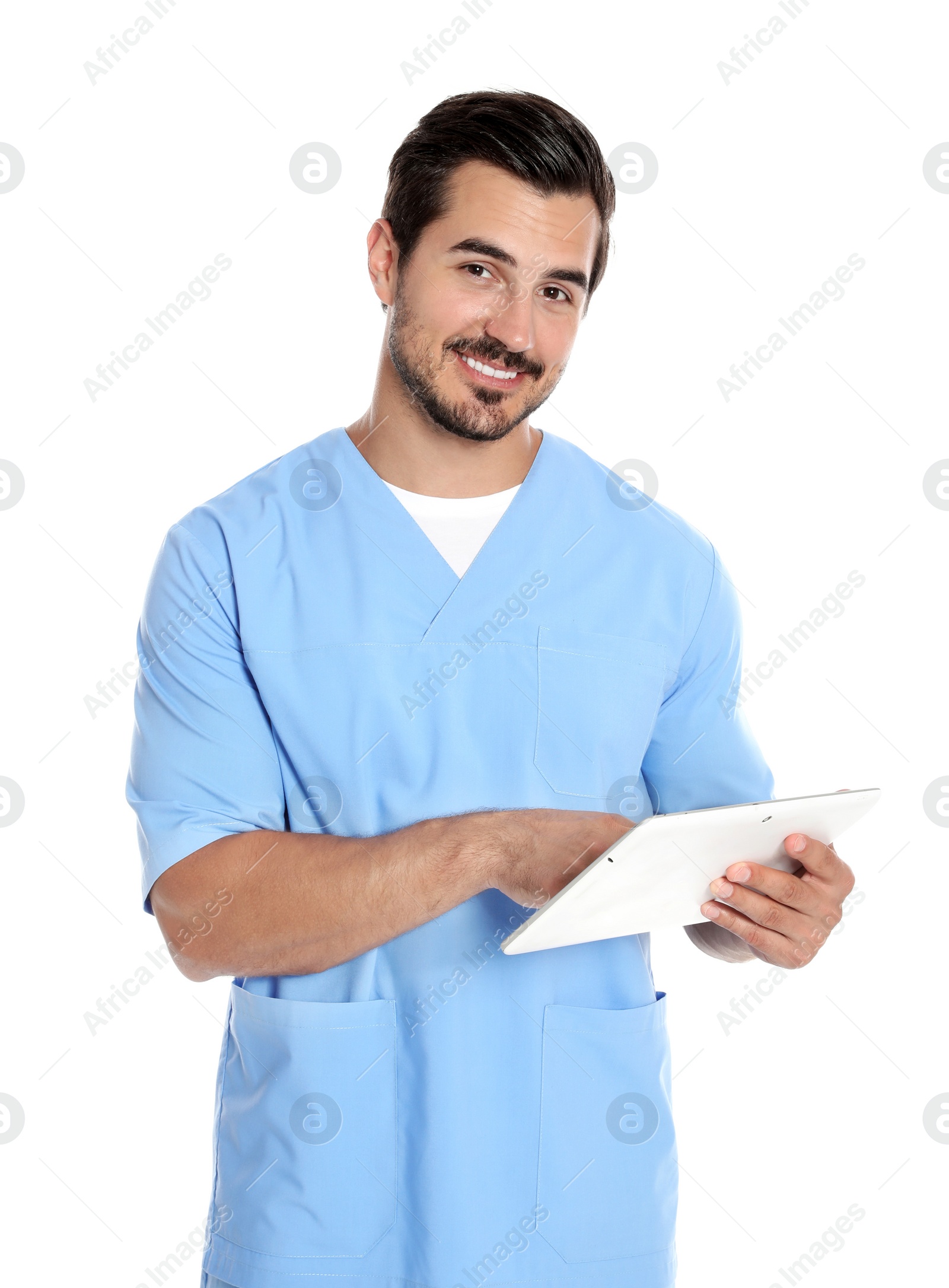 Photo of Young male doctor in uniform with tablet on white background. Medical service