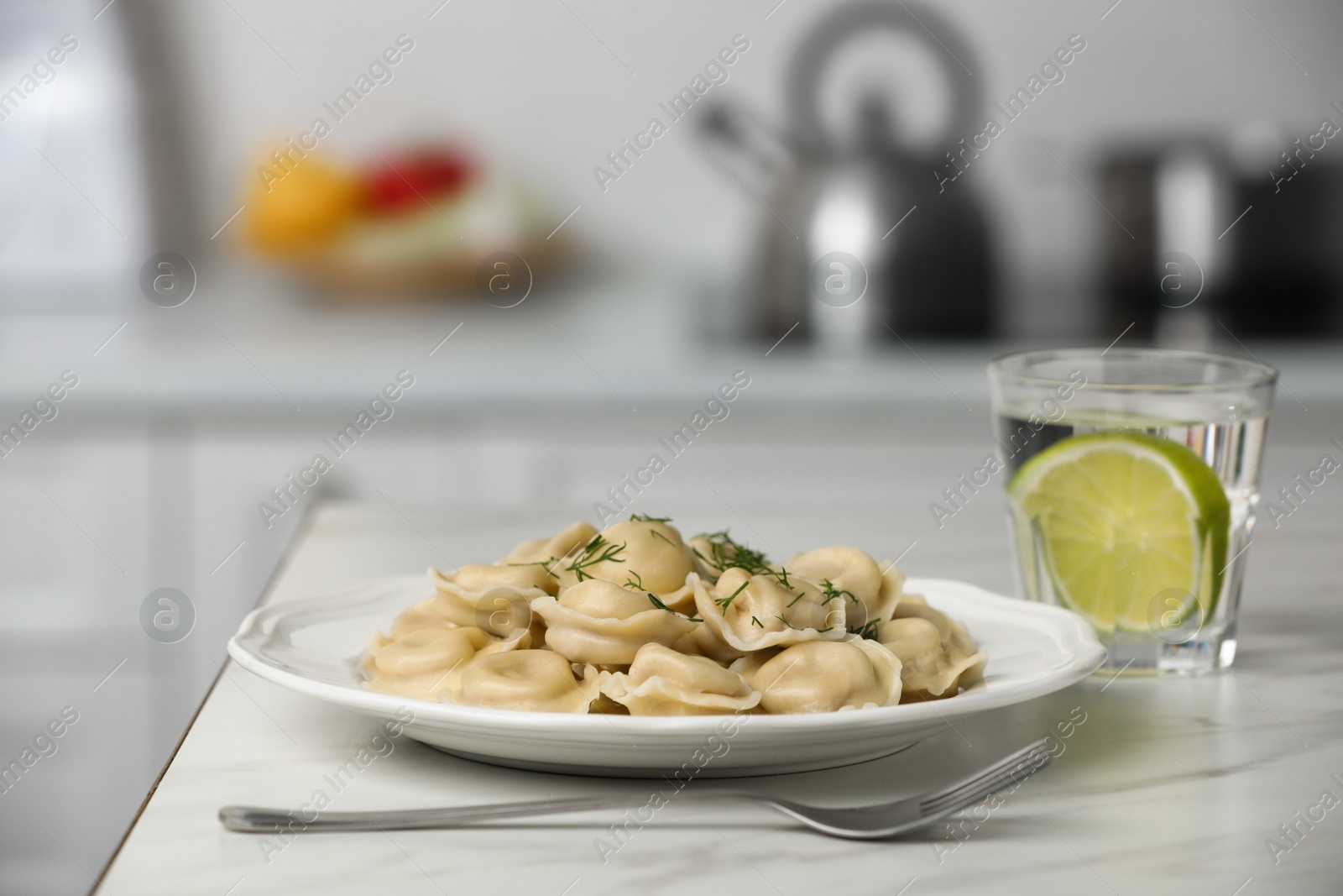 Photo of Delicious dumplings on white table in kitchen