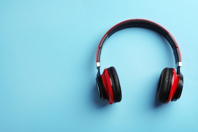 Photo of Wireless headphones on color background, top view. Space for text