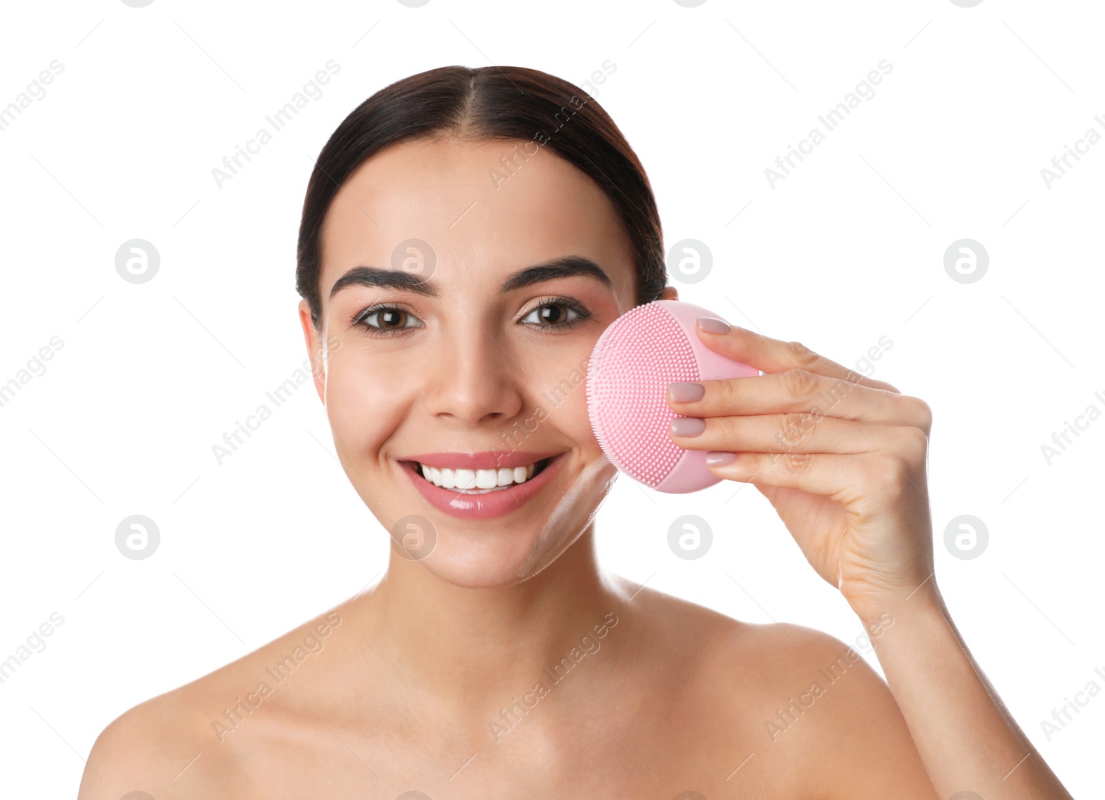 Photo of Young woman using facial cleansing brush on white background. Washing accessory