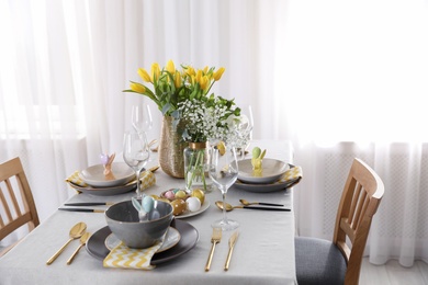 Photo of Beautiful Easter table setting with festive decor indoors