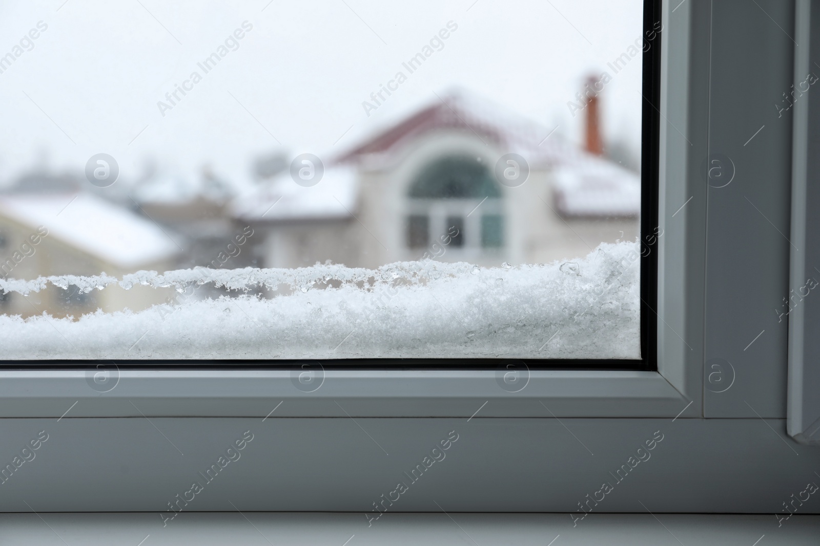 Photo of Closeup view of window covered with snow on winter day