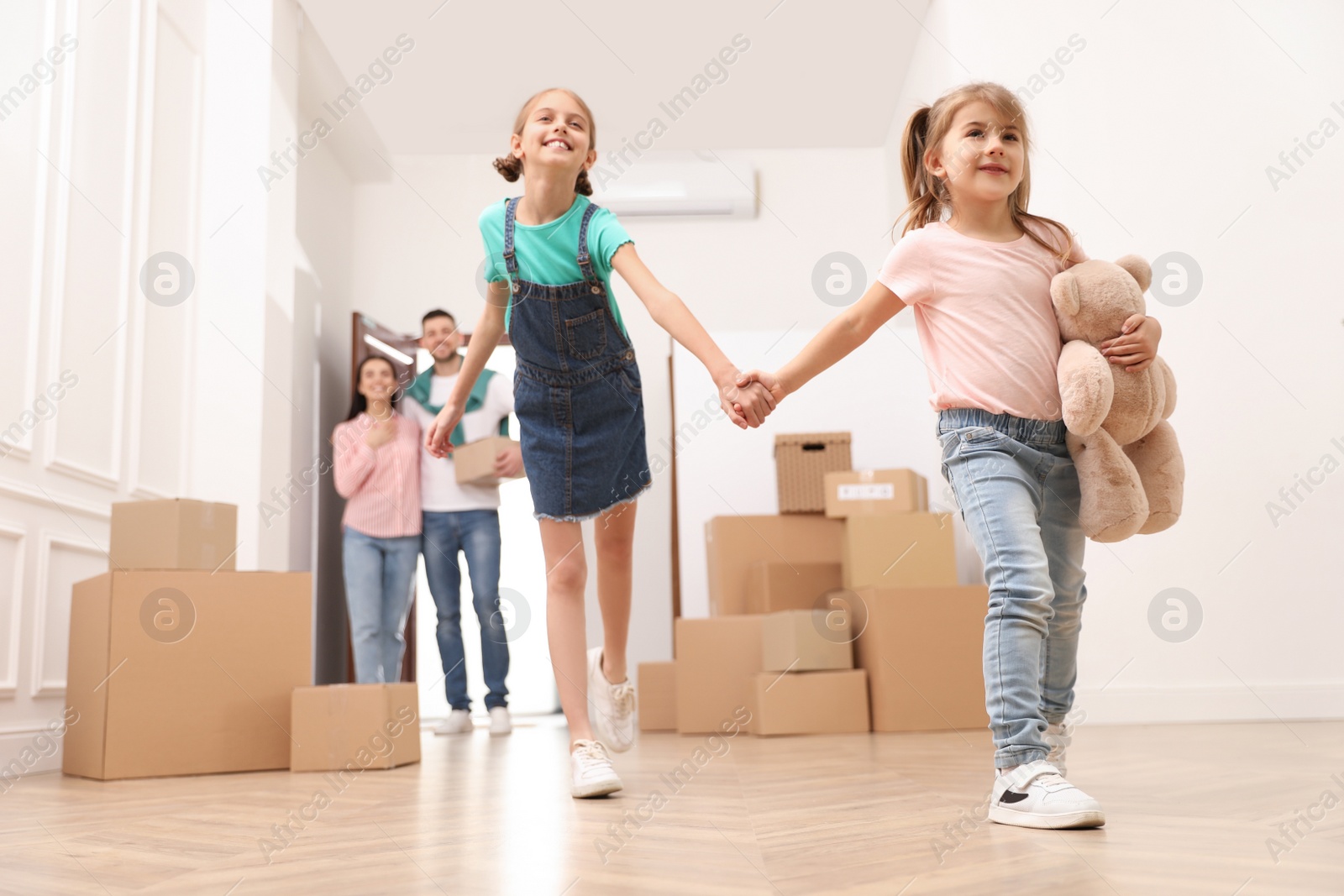 Photo of Happy family with children moving into new house, low angle view