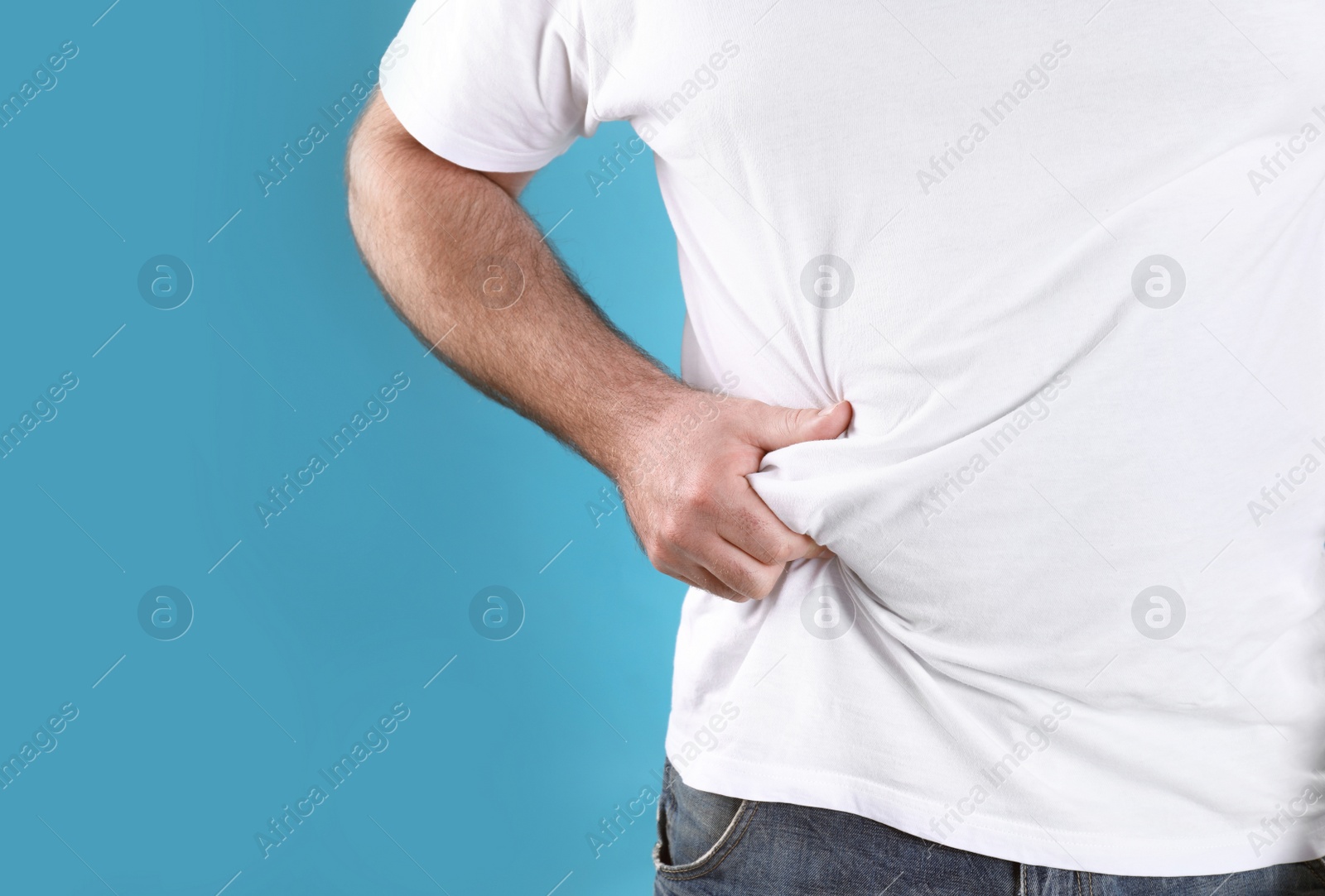 Photo of Overweight man with large belly on color background, closeup