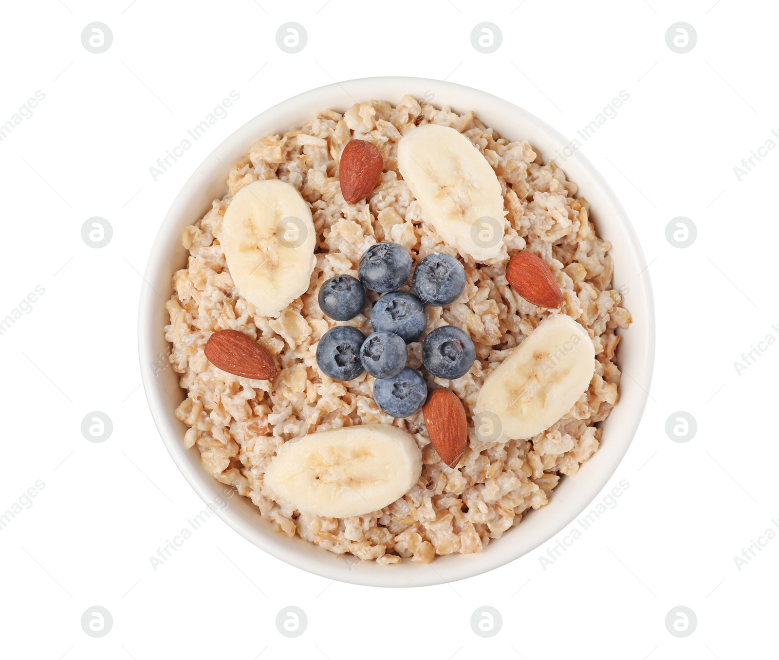 Photo of Tasty boiled oatmeal with blueberries, banana and almonds in bowl isolated on white, top view