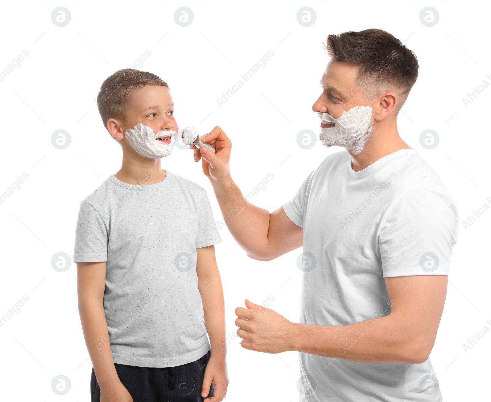 Photo of Dad applying shaving foam on son's face, white background