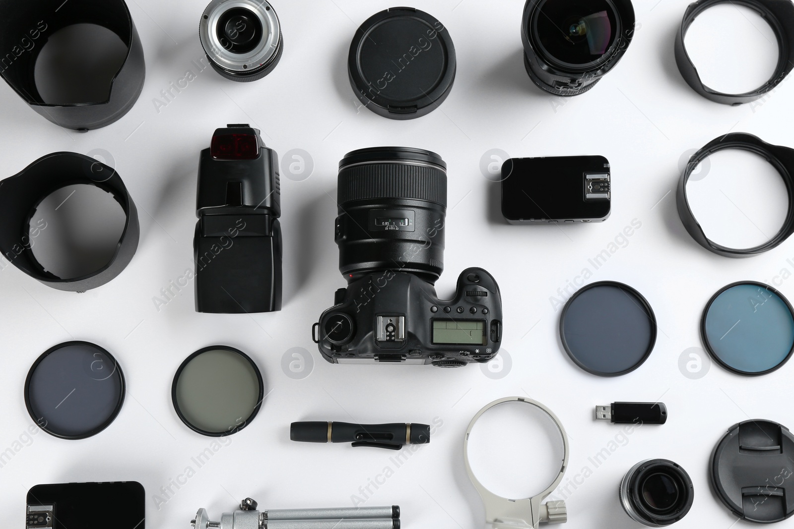 Photo of Flat lay composition with equipment for professional photographer on white background