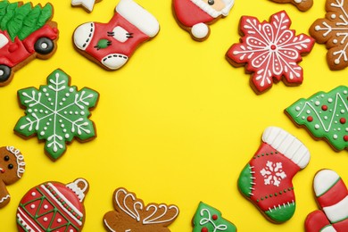 Photo of Different tasty Christmas cookies on yellow background, flat lay. Space for text