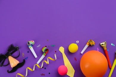 Photo of Flat lay composition with clown's accessories on purple background. Space for text