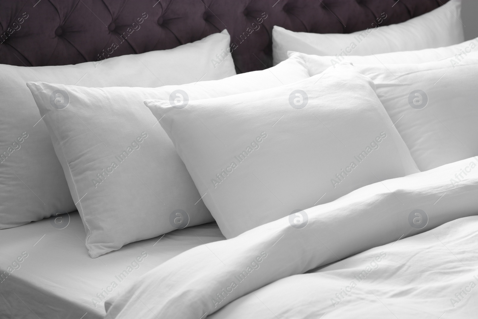 Photo of Modern bed with soft pillows in room