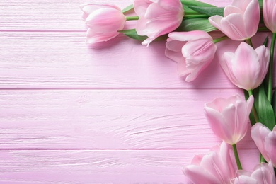 Beautiful composition with tulips for Mother's Day on wooden background