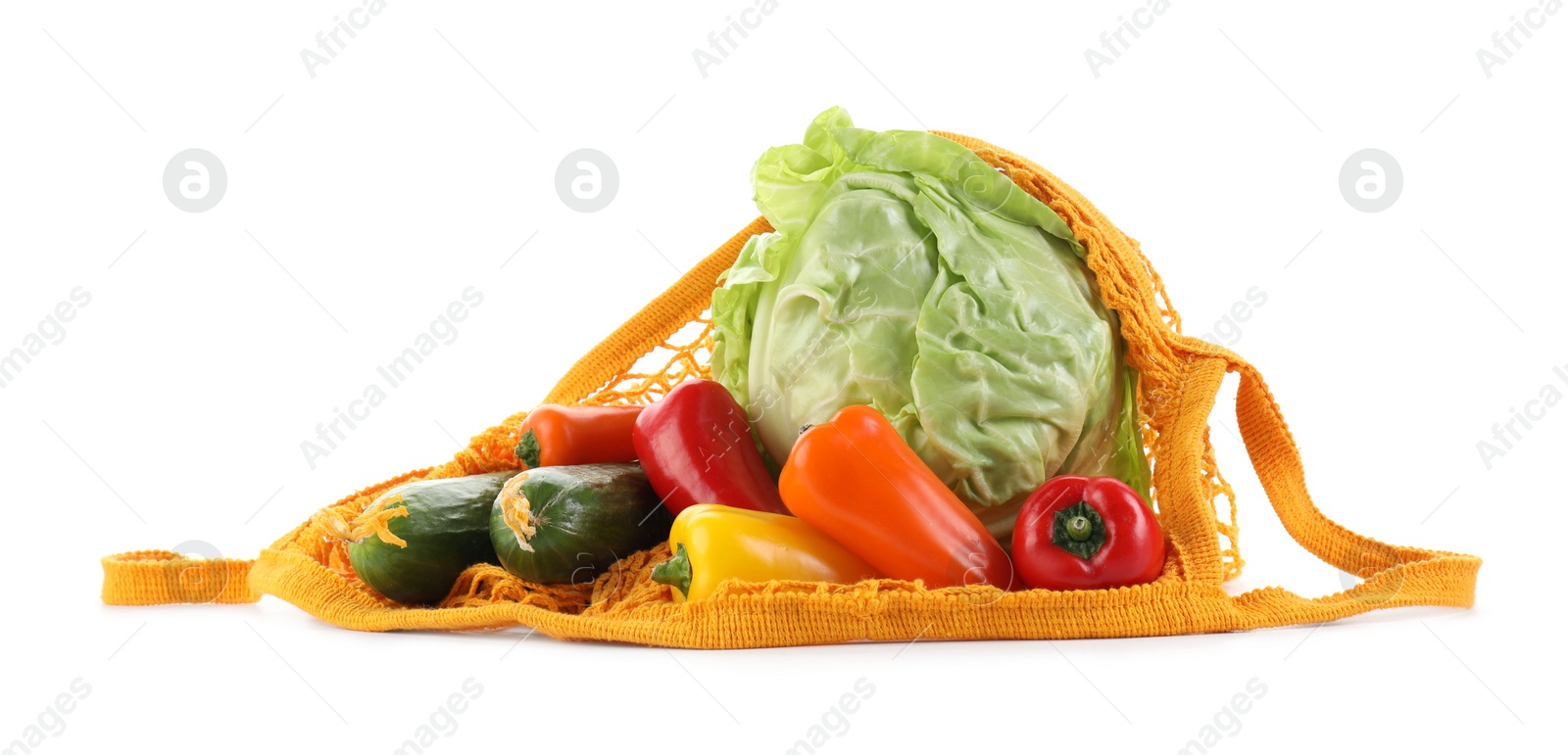 Photo of String bag with different vegetables isolated on white