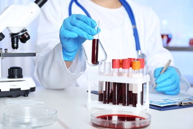 Photo of Female scientist working at table in laboratory. Research and analysis