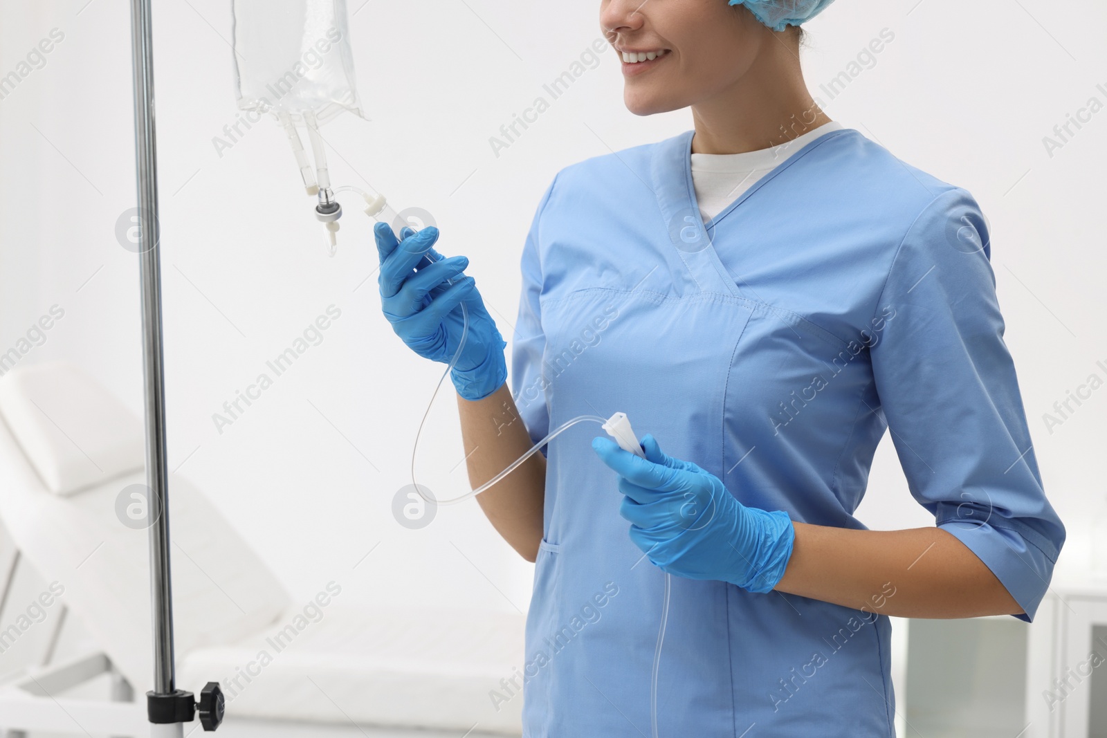 Photo of Nurse setting up IV drip in hospital, closeup