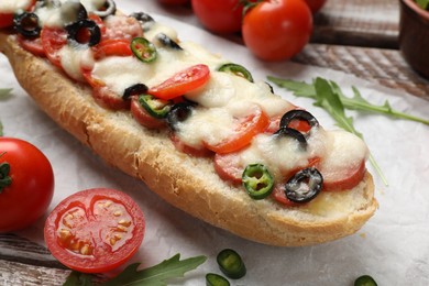 Tasty pizza toast and ingredients on wooden table, closeup