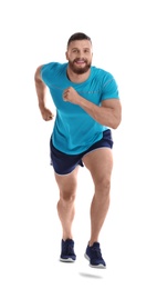 Young man in sportswear running on white background