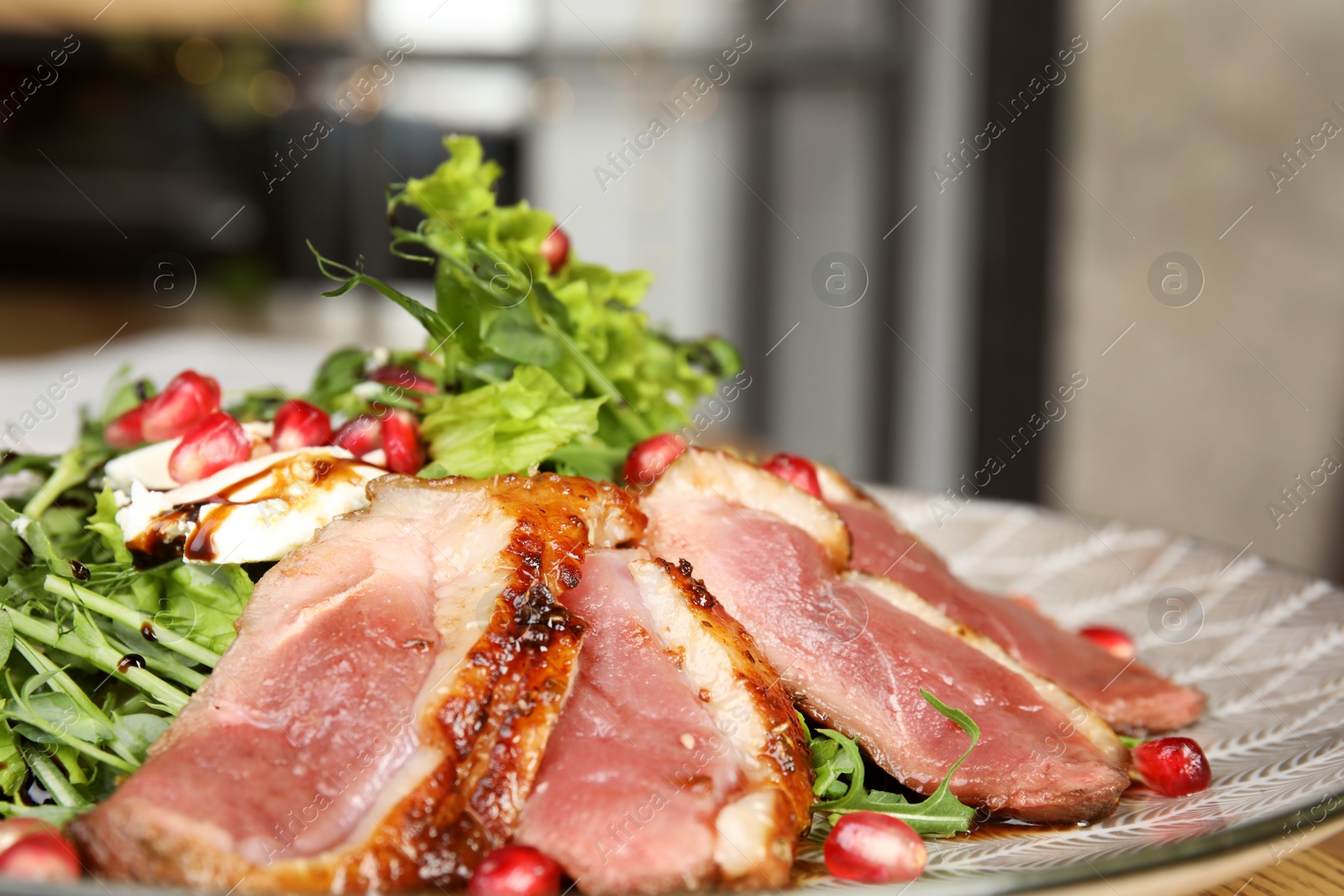 Photo of Delicious salad with roasted duck breast on plate, closeup