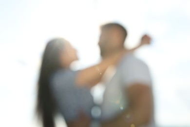 Romantic date. Blurred view of beautiful couple spending time together against blue sky