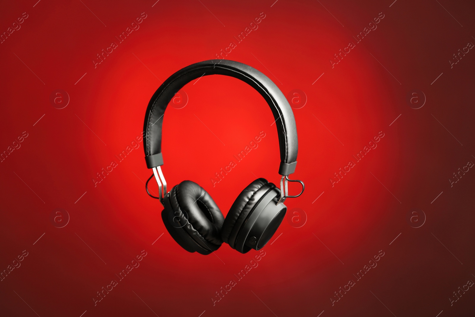 Photo of Stylish headphones with pads on color background