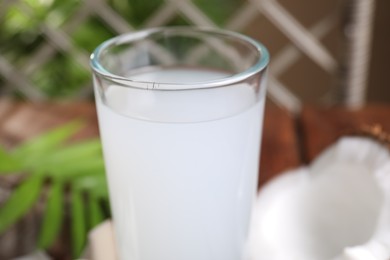 Photo of Glass of coconut water on table, closeup