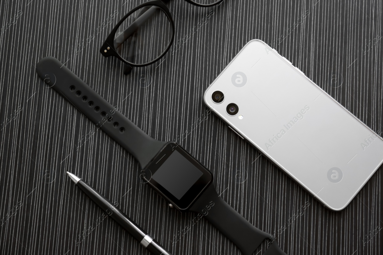 Flat lay composition with stylish smart watch on black table Photo of Flat lay composition with stylish smart watch on black table