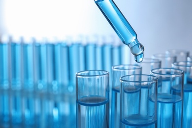 Dripping reagent into test tube with sample, closeup. Laboratory analysis