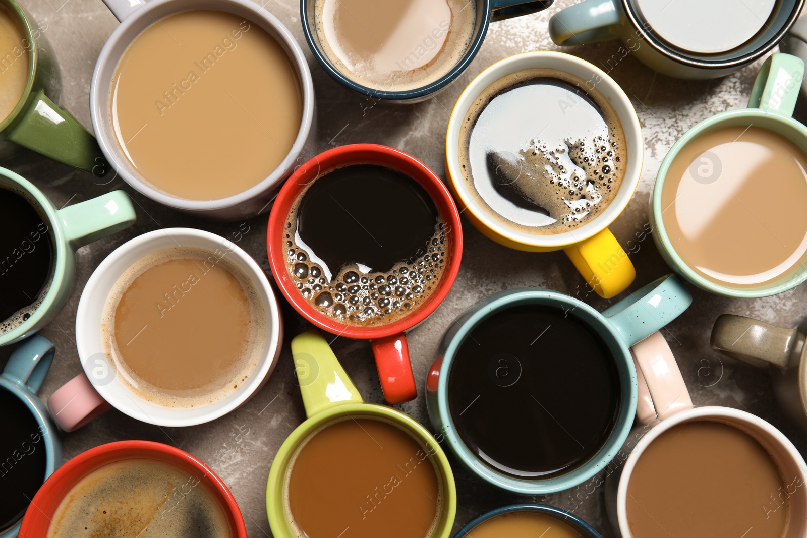 Photo of Cups of fresh aromatic coffee on gray background, top view. Food photography