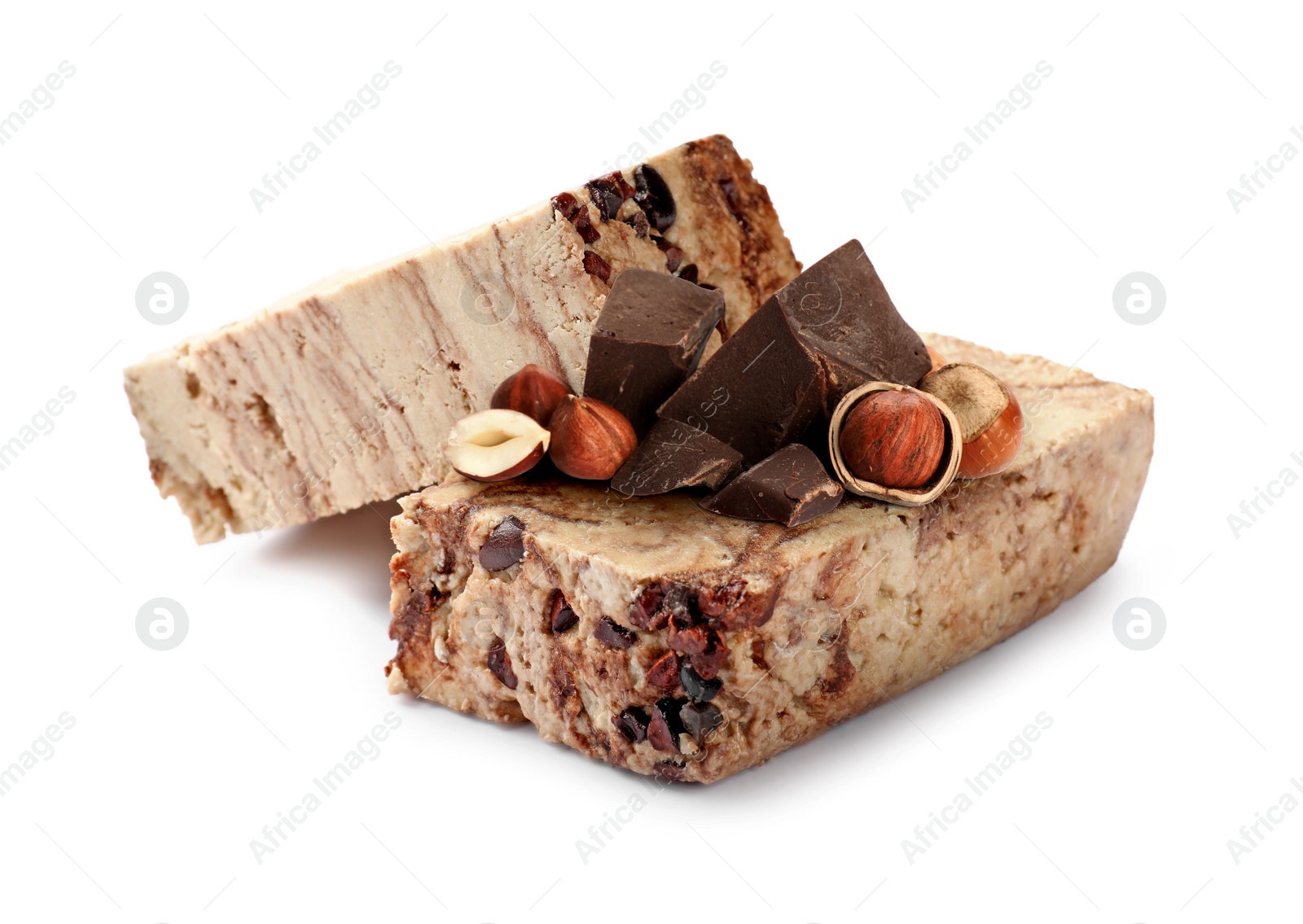 Image of Tasty halva, pieces of chocolate and hazelnuts isolated on white