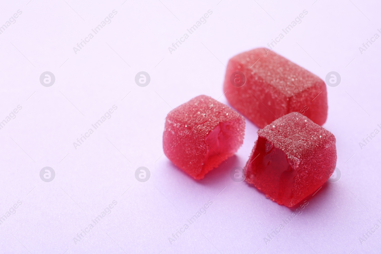 Photo of Tasty jelly candies on color background, space for text